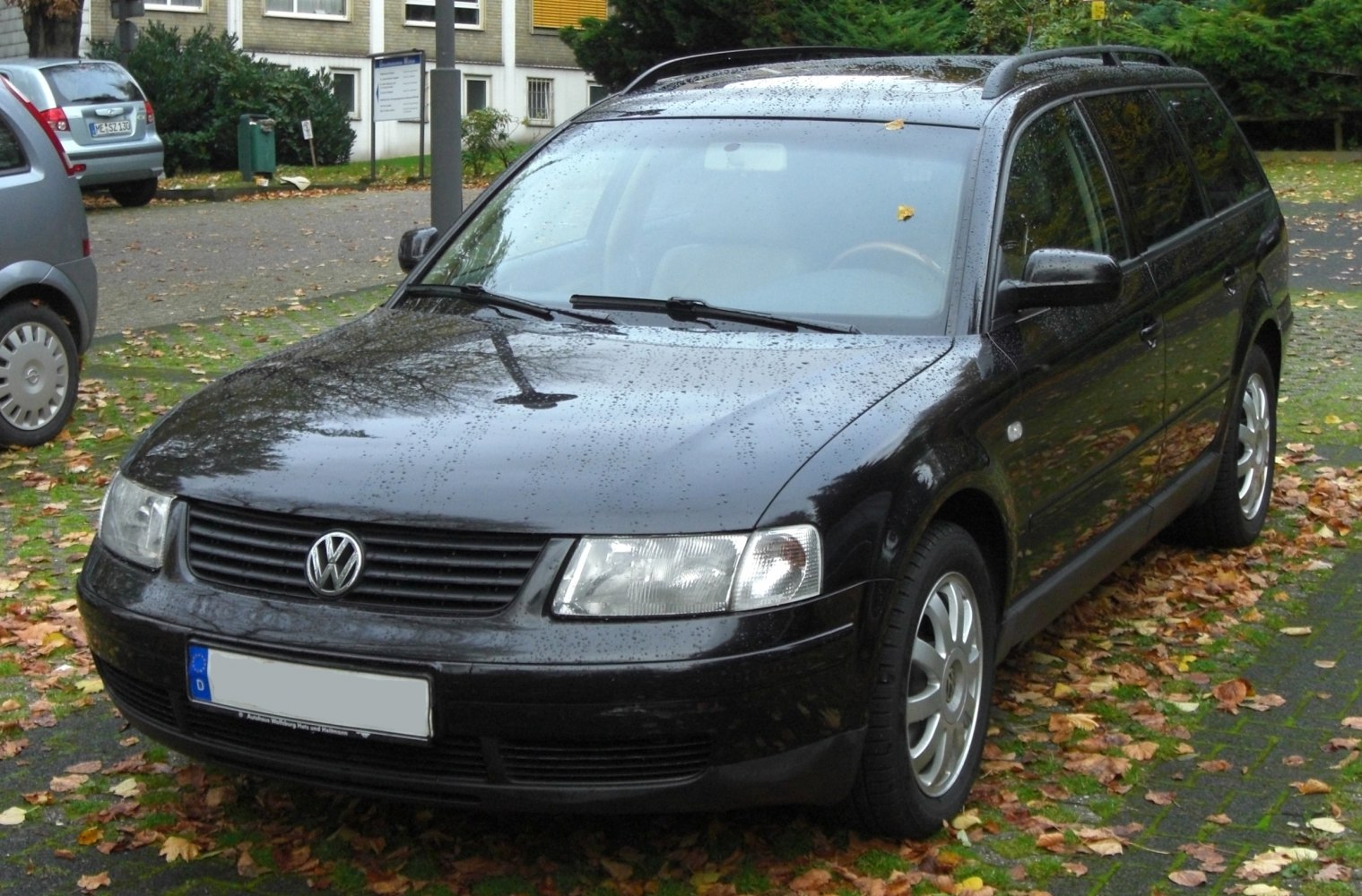 Front view of a black station wagon with roof rails and classic headlights.