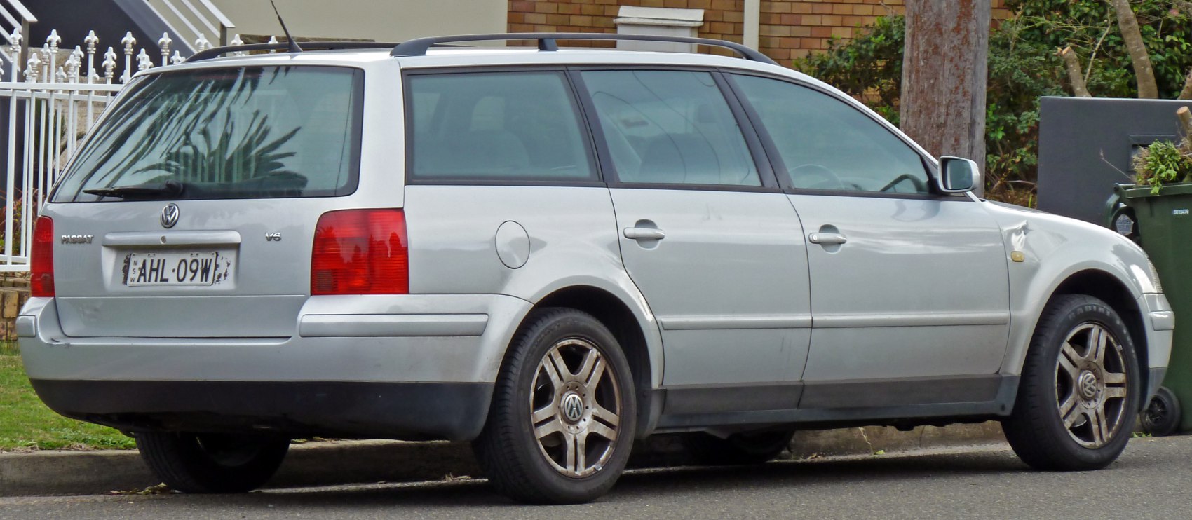 Rear and side profile of a silver estate car with V6 badge