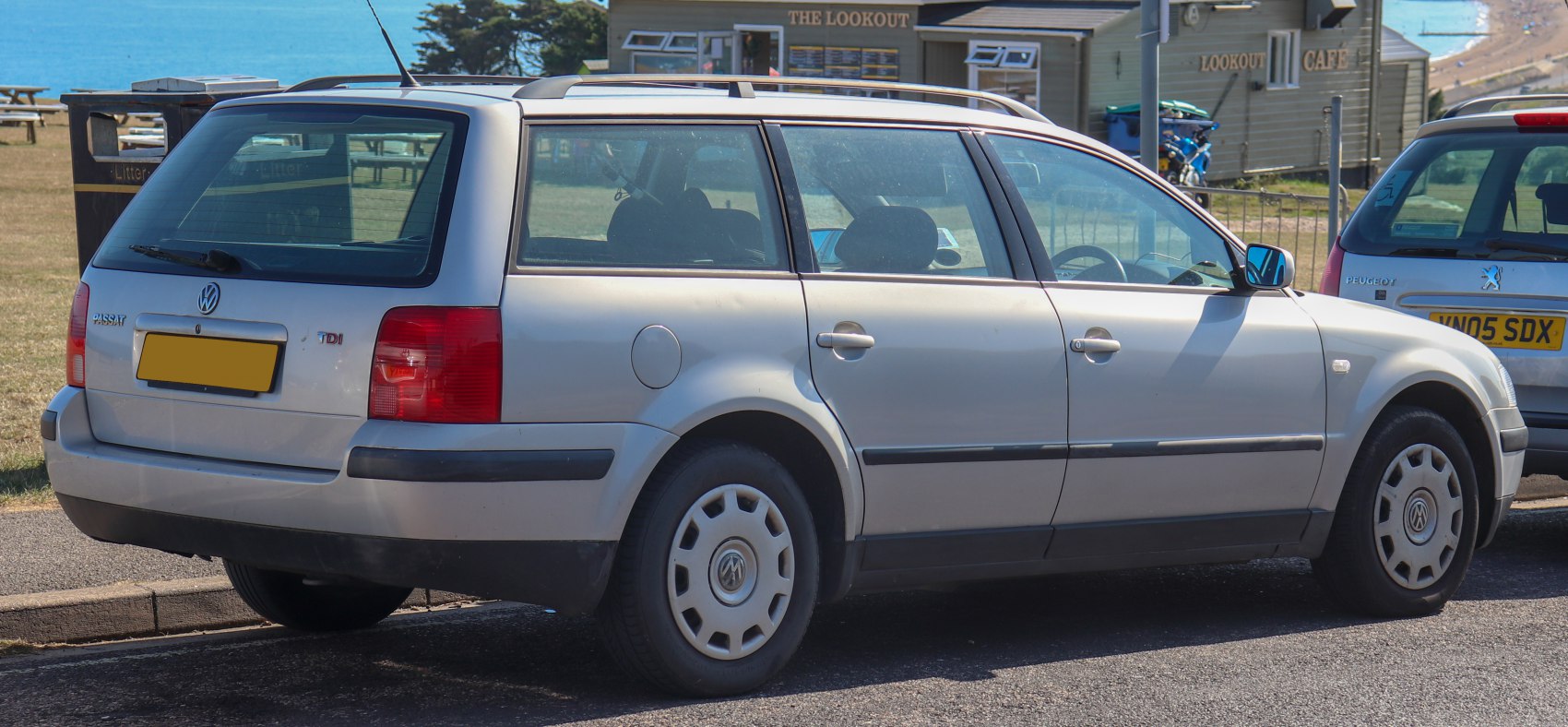 Rear-side view of a silver station wagon with distinctive rear lights