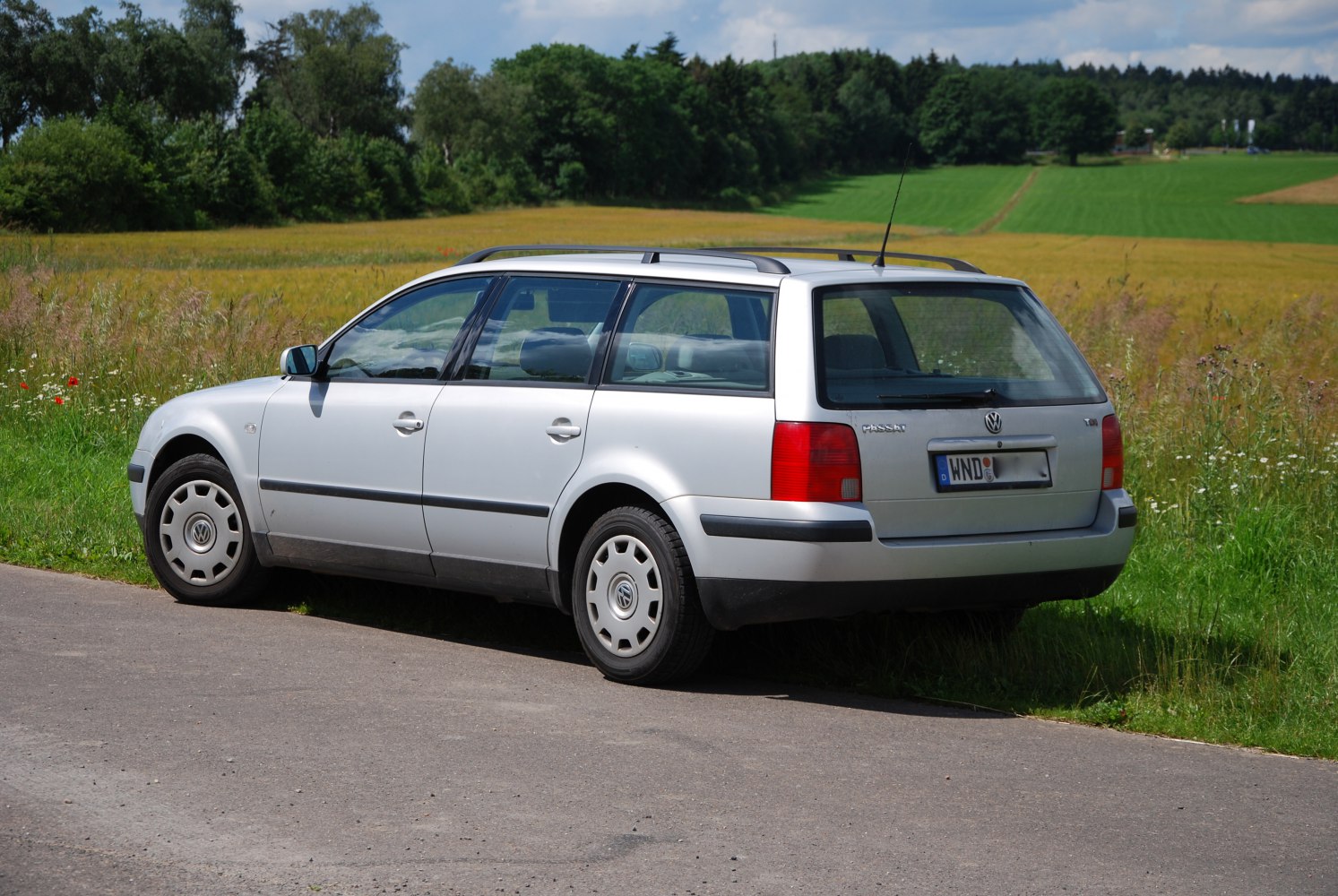 Silver station wagon with roof rails and classic rectangular taillights