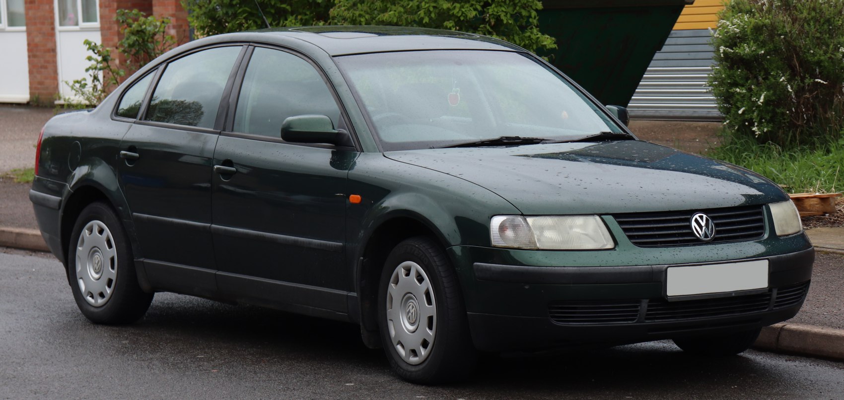 Dark green sedan with rectangular headlights and classic side profile