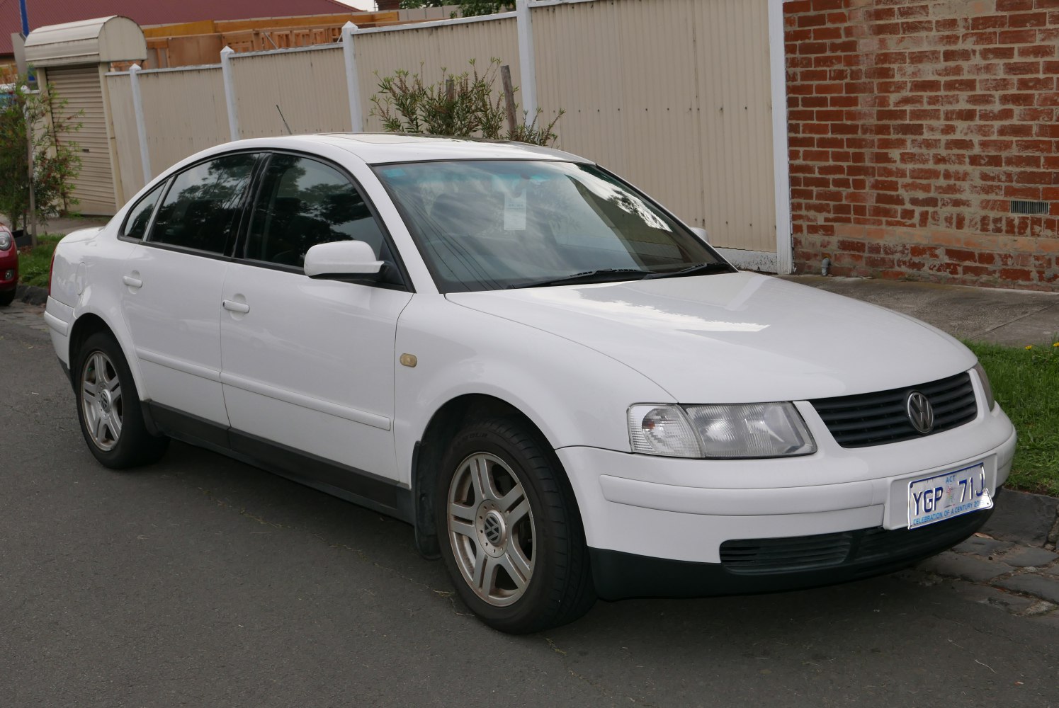 White sedan with front side view and alloy wheels