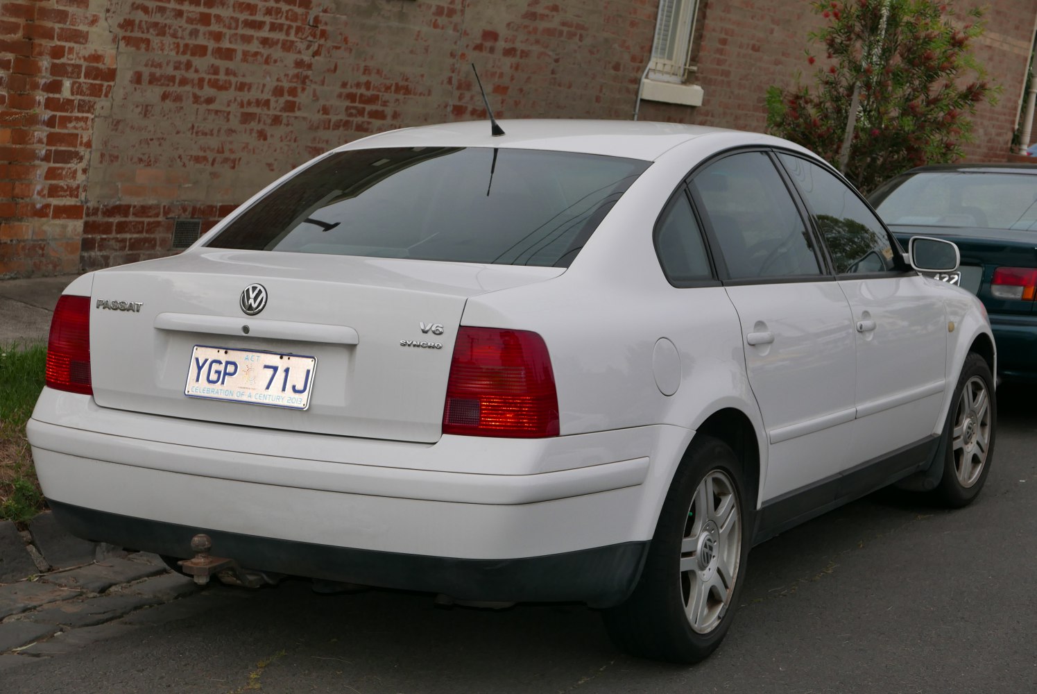 Rear view of a sedan with V6 Syncro badge and distinctive taillights