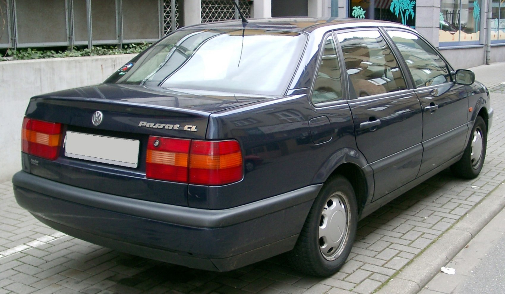 Rear side view showing tail lights and design of classic sedan.