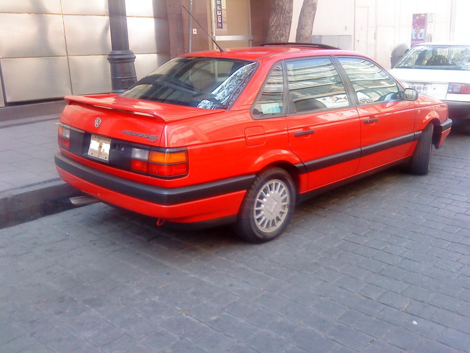 Red sedan with rear spoiler and rectangular tail lights