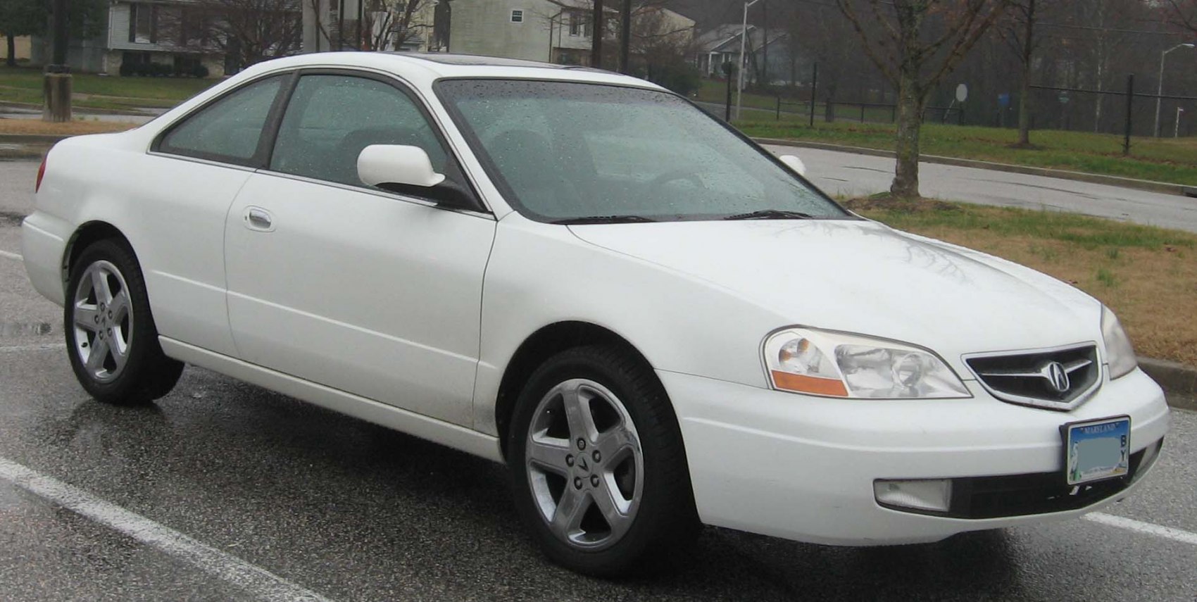 White coupe highlighting side profile and front exterior with alloy wheels