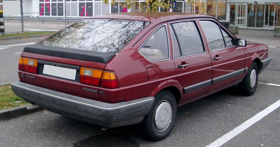 Red hatchback with distinctive rear lights and trim in parking space