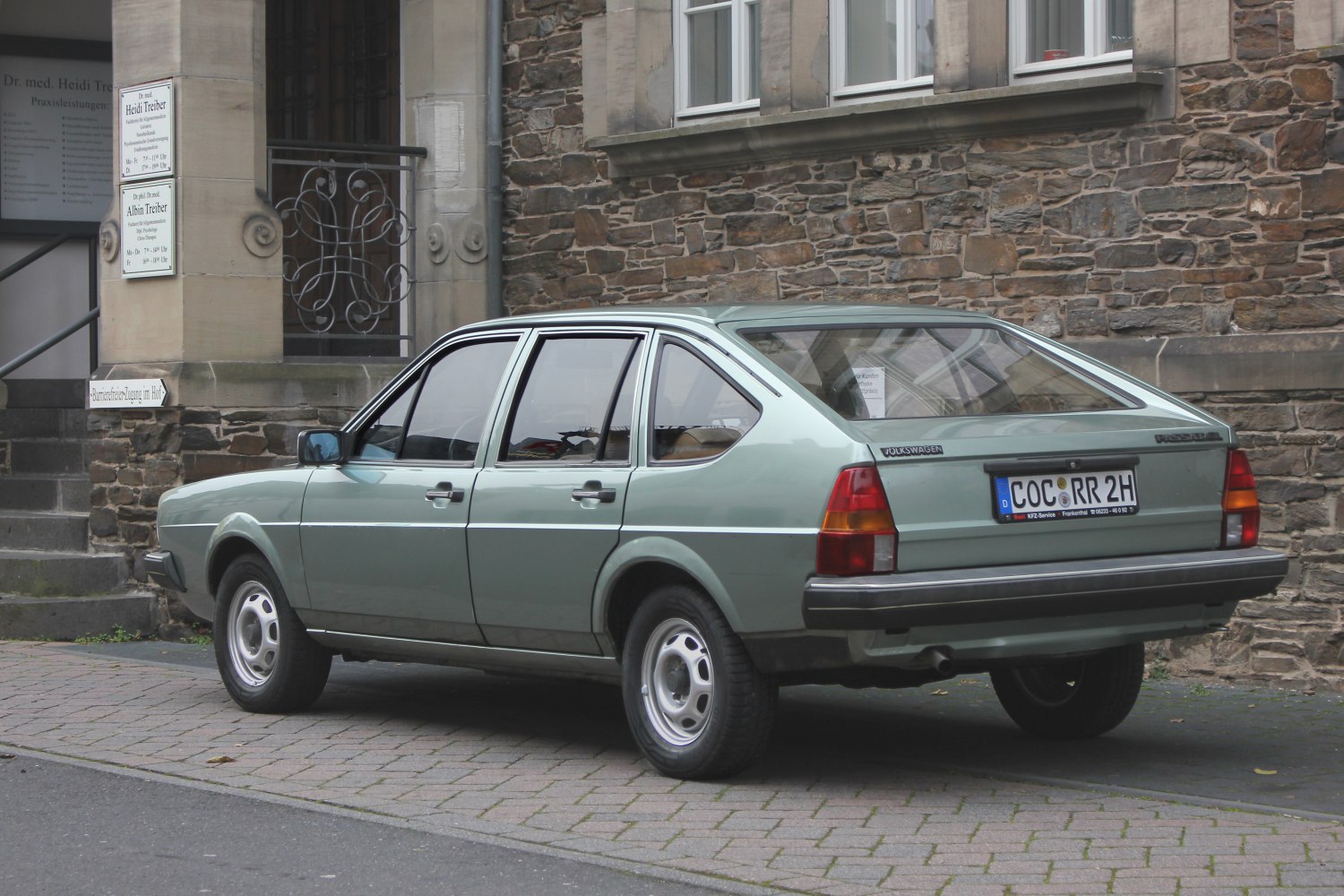 Rear side view of a classic hatchback with angular design and distinctive rear window.