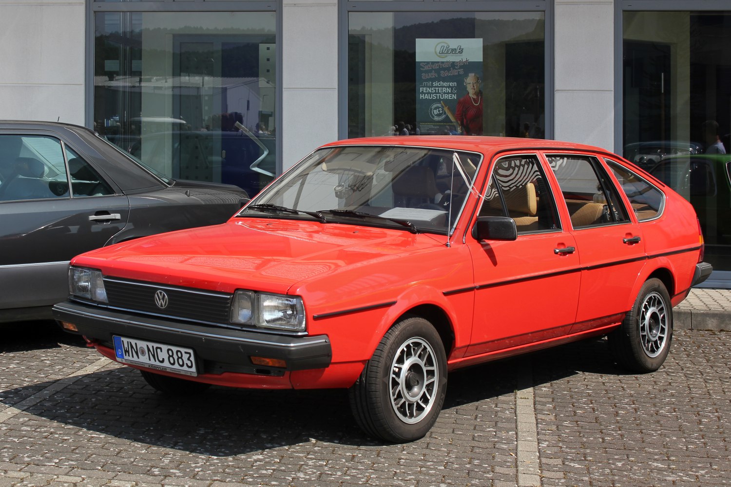 Red vintage angular hatchback with alloy wheels