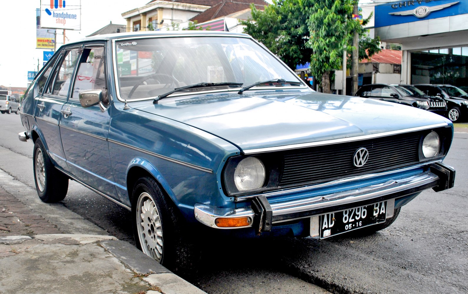 Retro 1970s vintage hatchback with round headlights and chrome bumper.