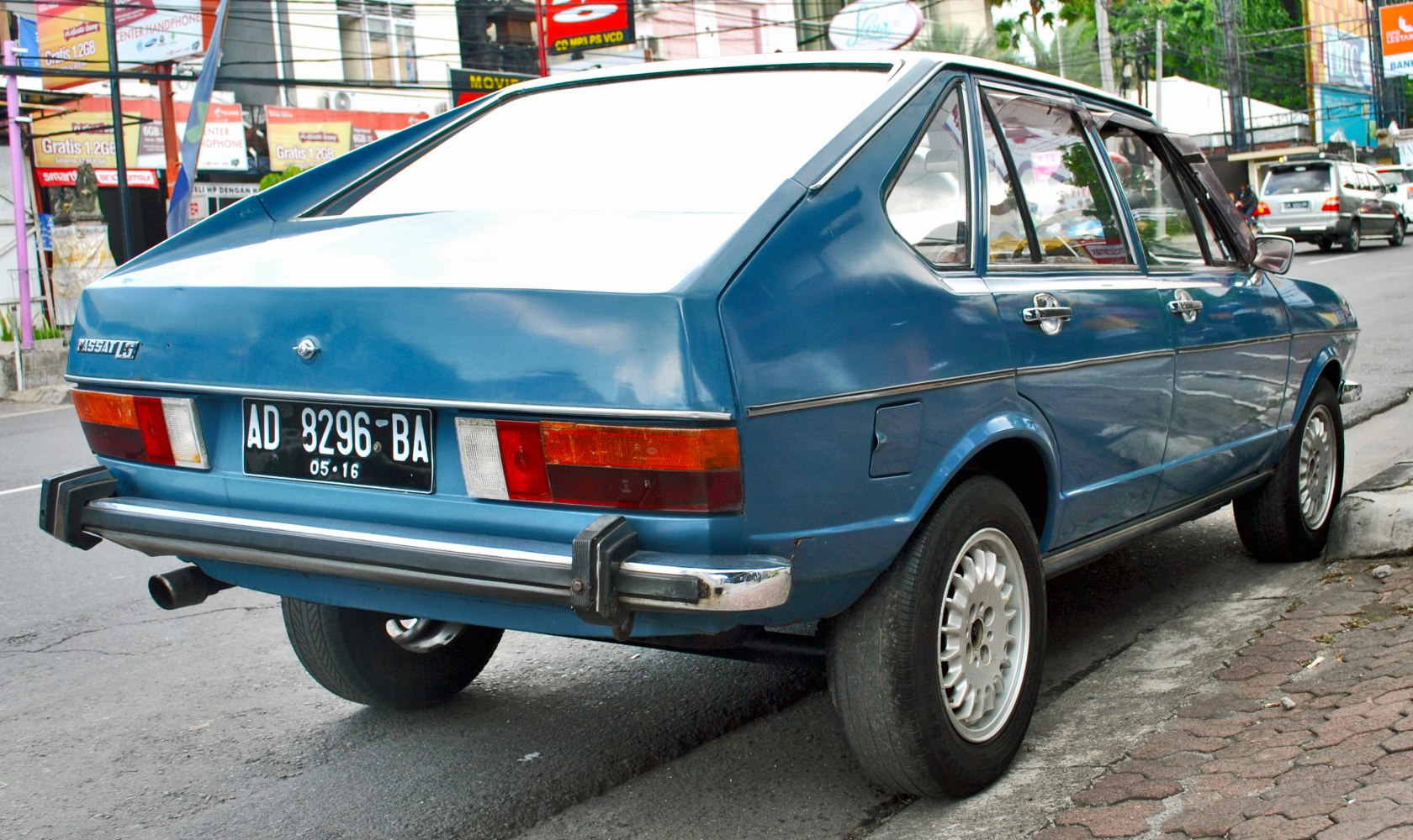 Angular rear hatchback with chrome bumper and distinct taillights