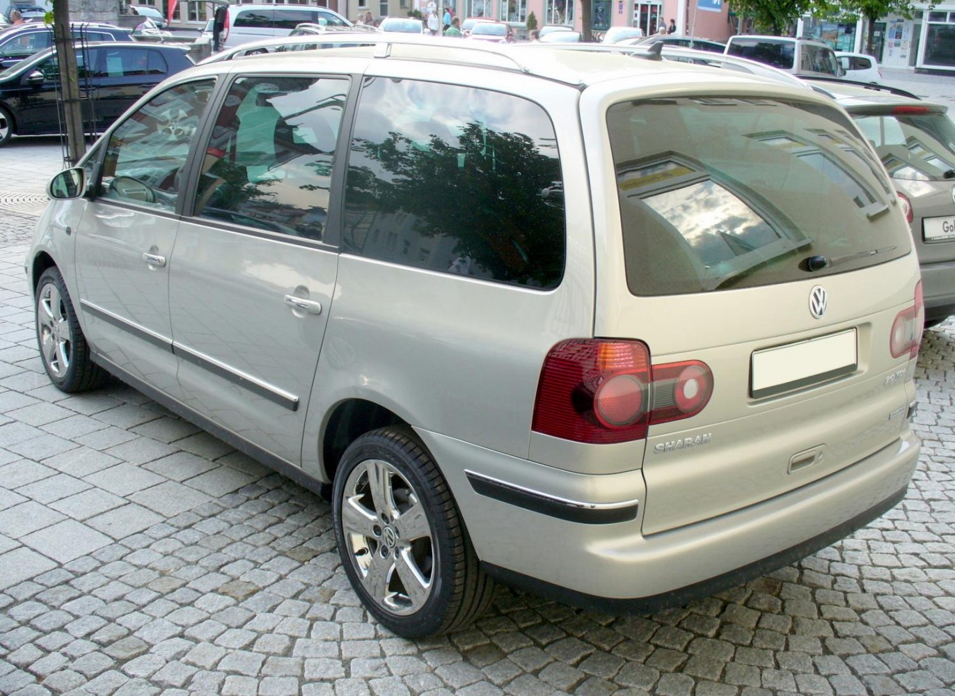 Rear and side view of minivan with tinted windows and alloy wheels