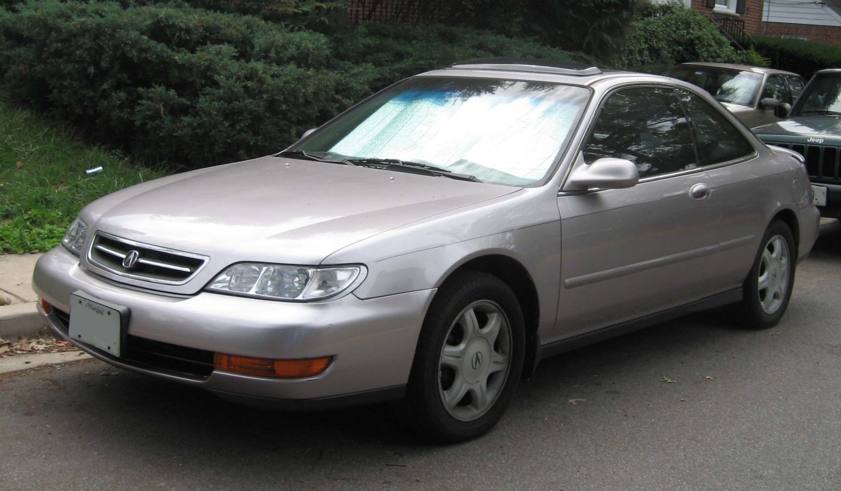 Front side view of a coupe with sunroof and alloy wheels