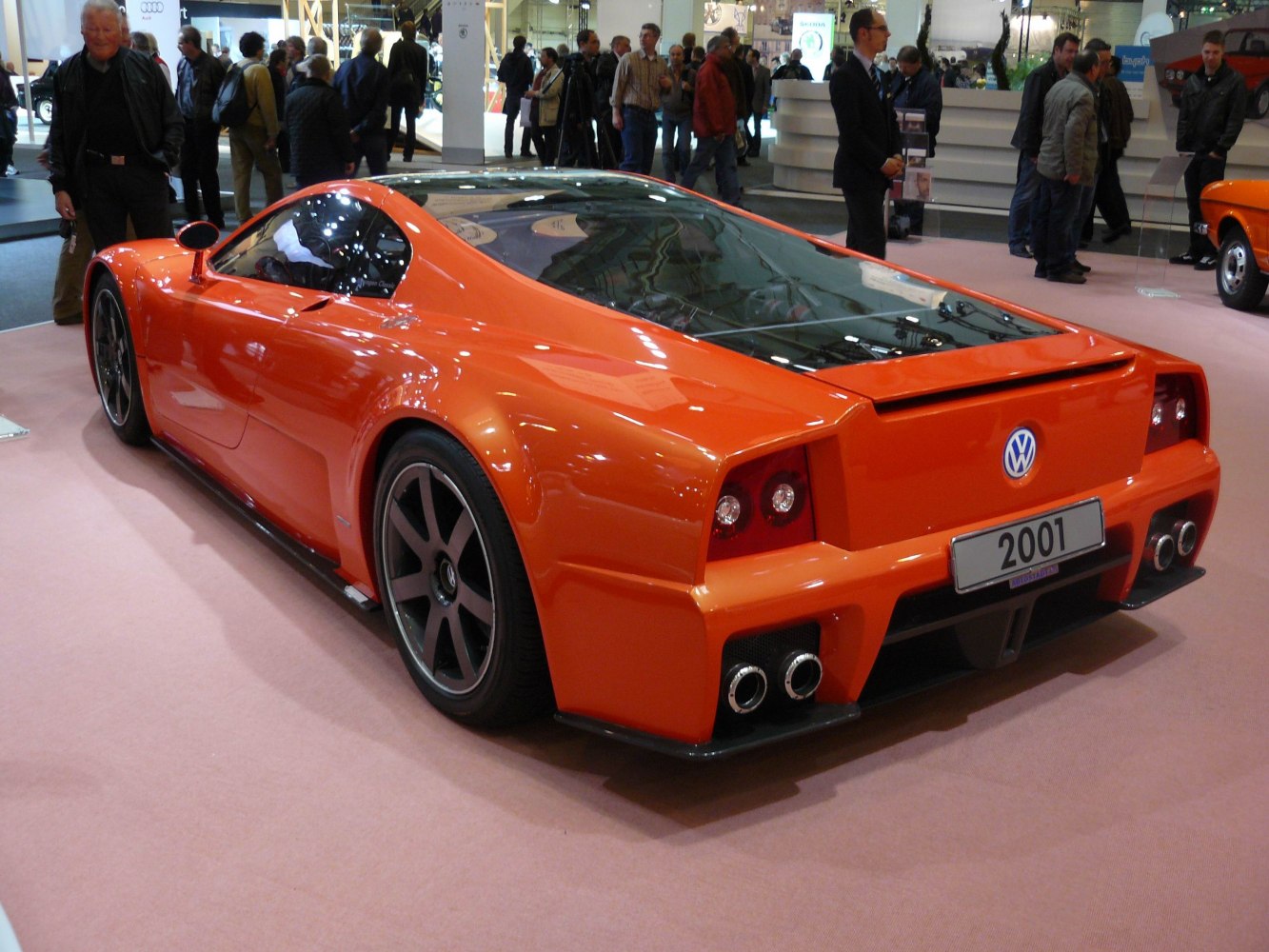 Orange supercar rear view with quad exhausts and aerodynamic design