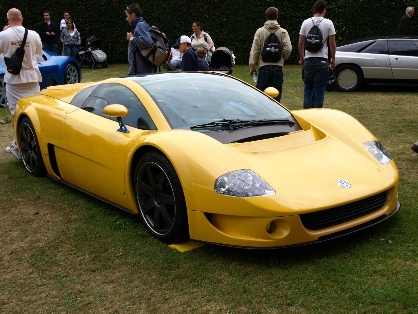 Yellow aerodynamic sports coupe with large black wheels