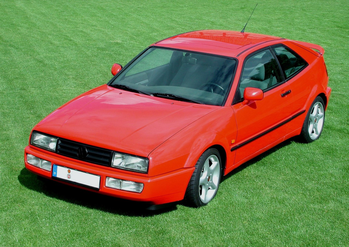 Red sporty hatchback with angular headlights and sloped roof