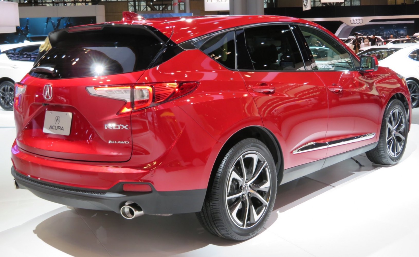 Rear side view of a red SUV with LED tail lights and alloy wheels