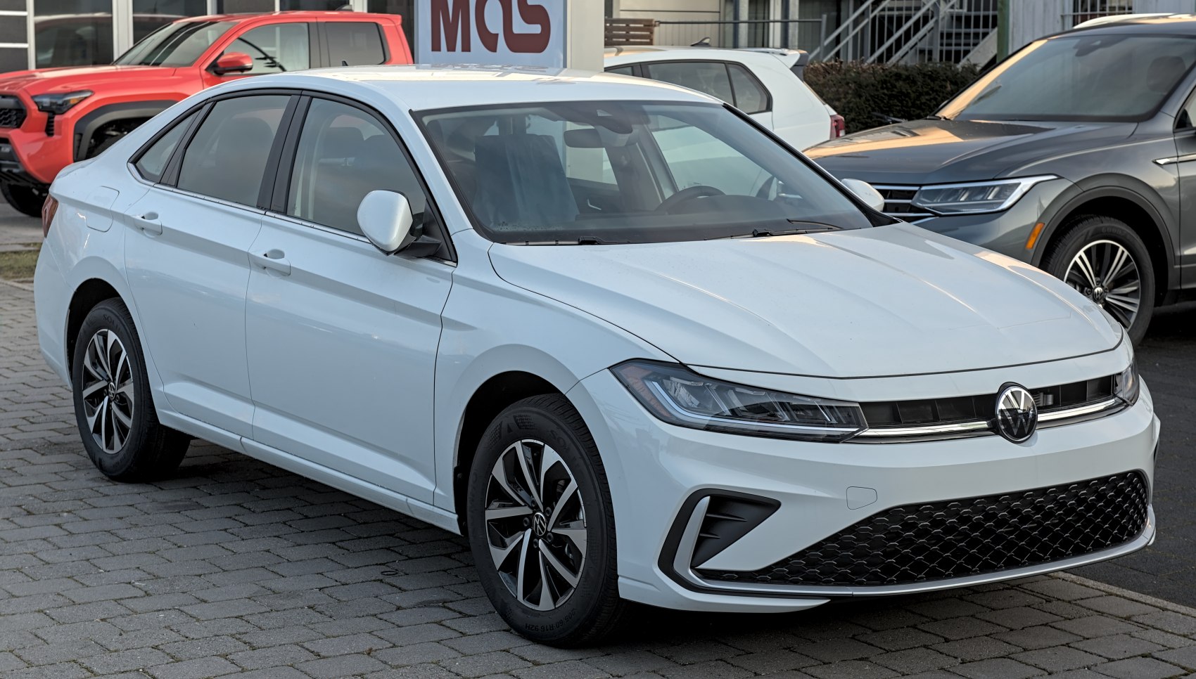 Front and side view with modern headlights and aerodynamic design