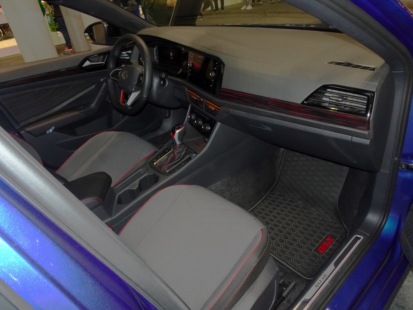 Digital dashboard and red-stitched seats interior