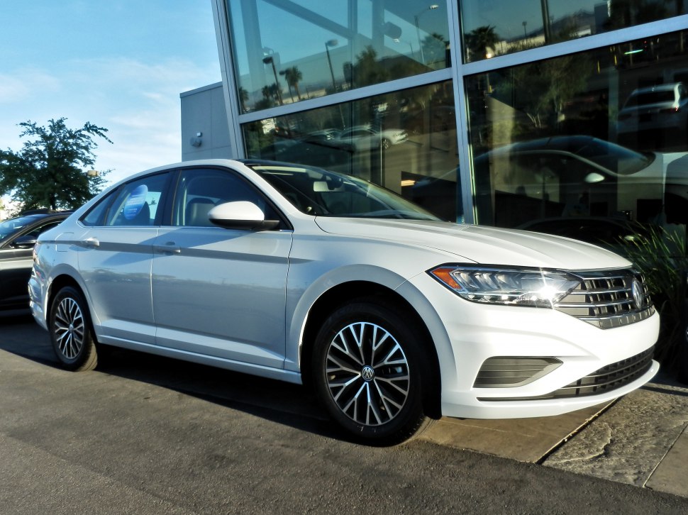 White sedan with front grille and alloy wheels