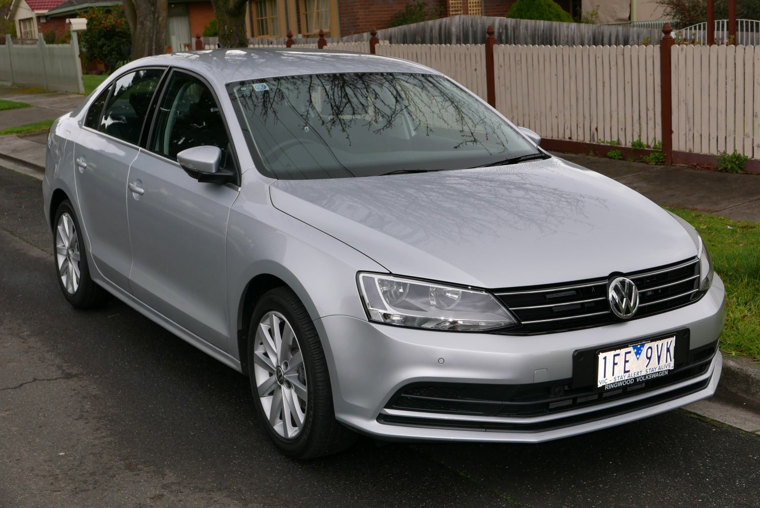 Silver sedan front and side with headlights and grille.