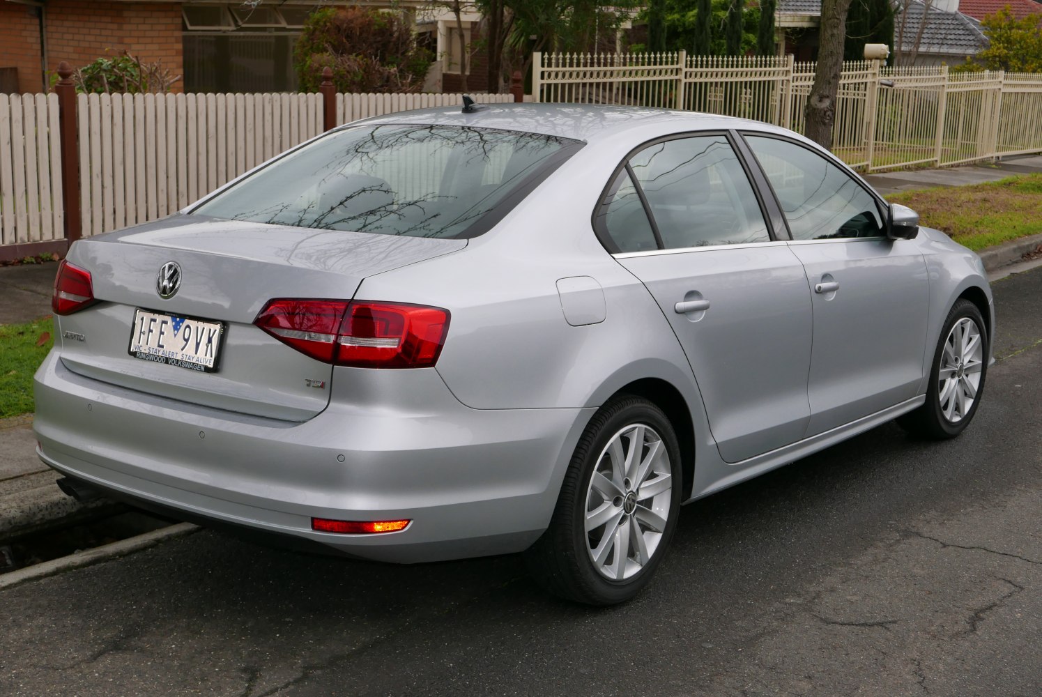 Silver sedan rear and side profile with alloy wheels and distinct taillights