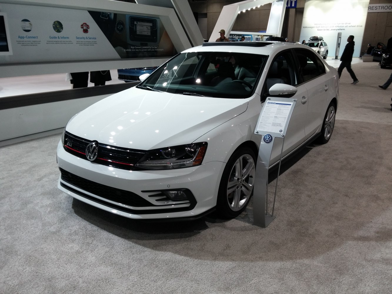 White sedan with sleek headlights and alloy wheels front view