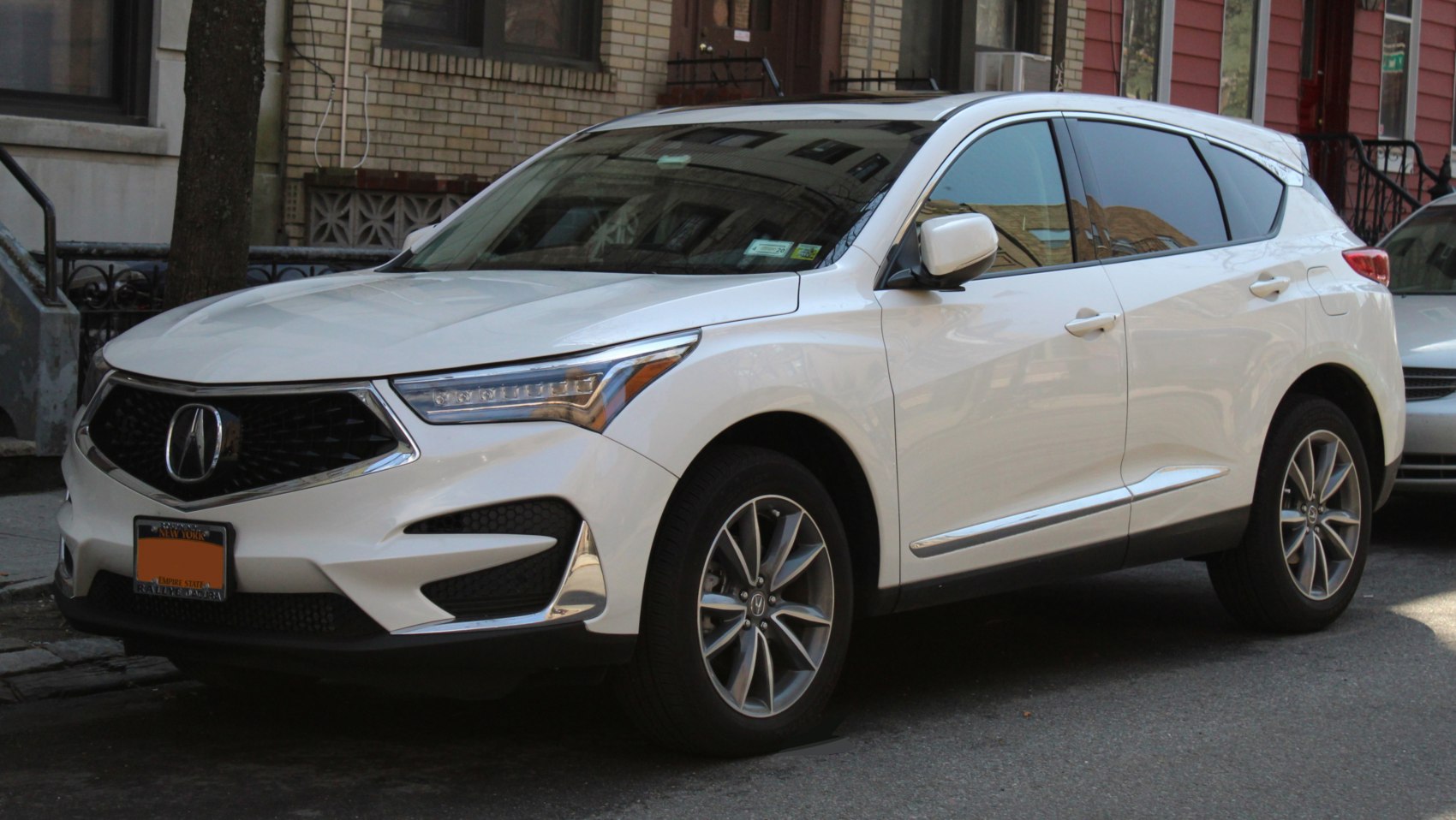 Front side view of white SUV with LED headlights and alloy wheels