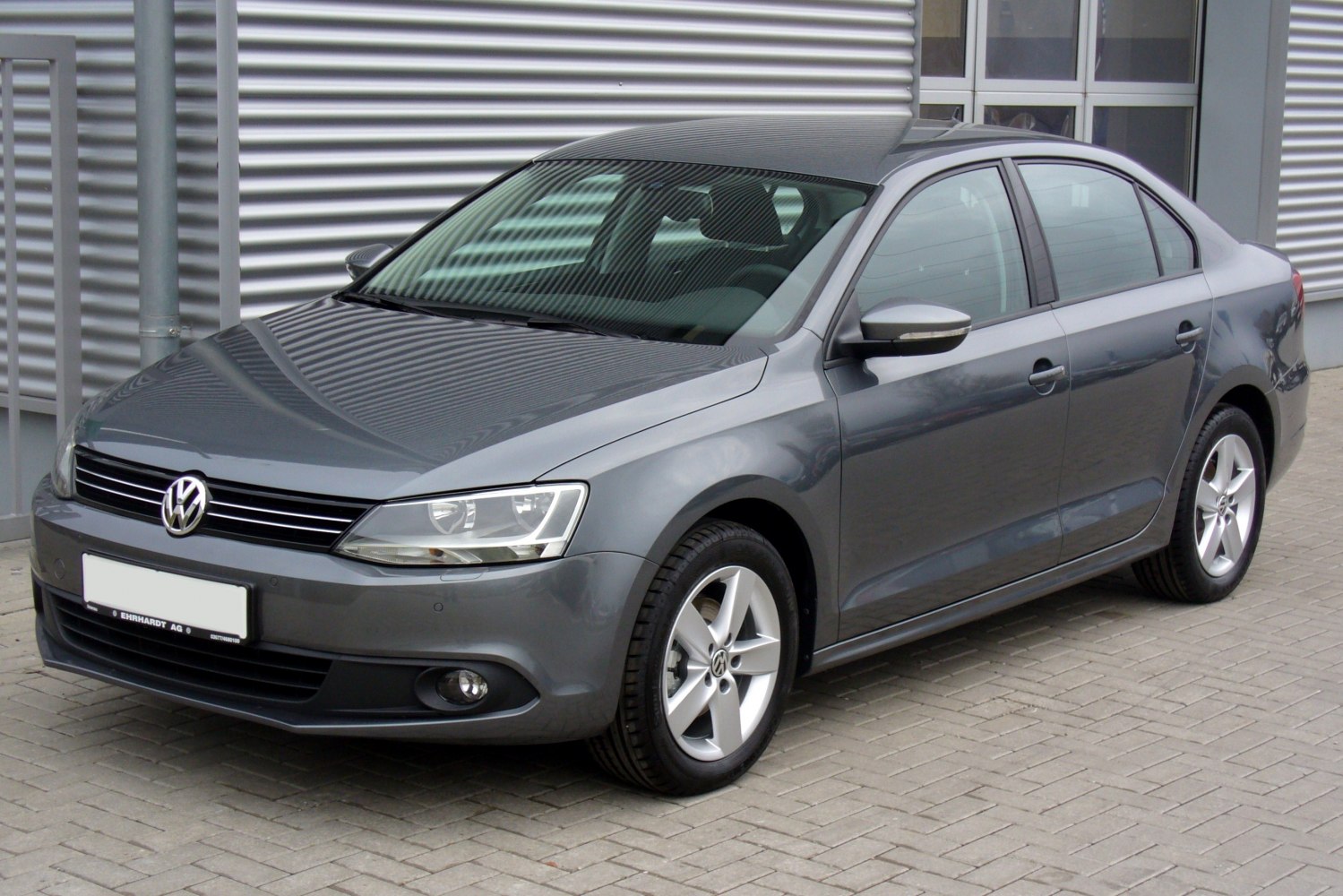 Front side view of a sedan with alloy wheels and clear headlights
