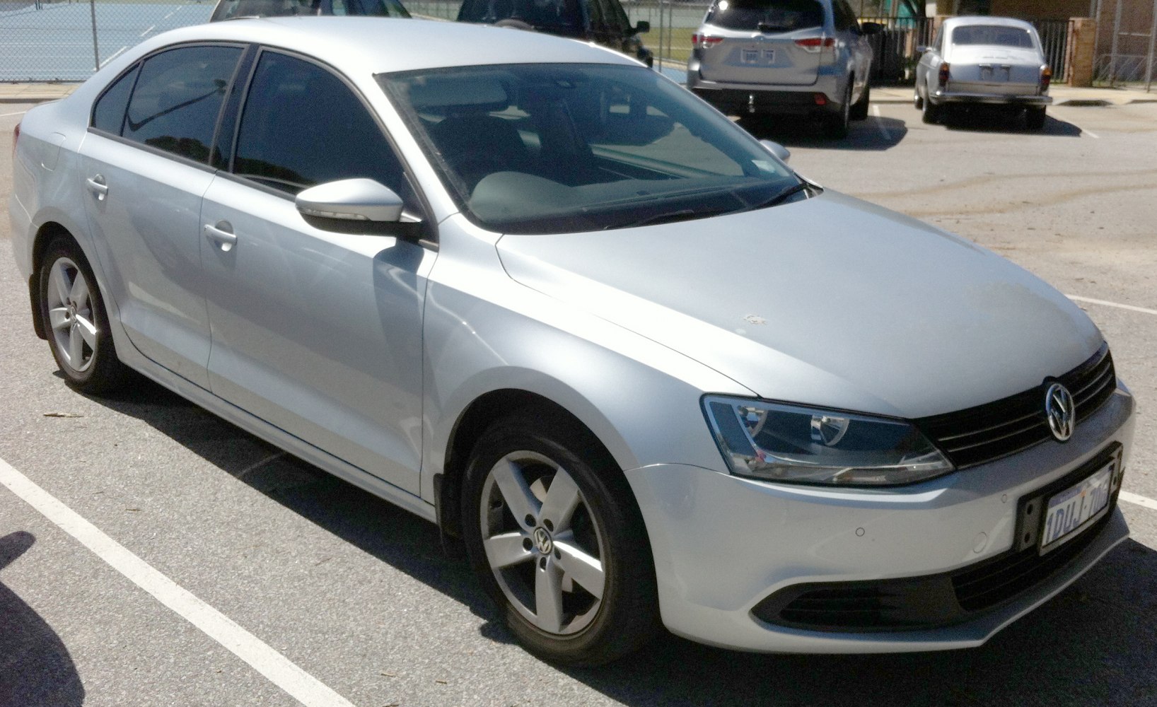 Silver sedan with alloy wheels and tinted windows parked
