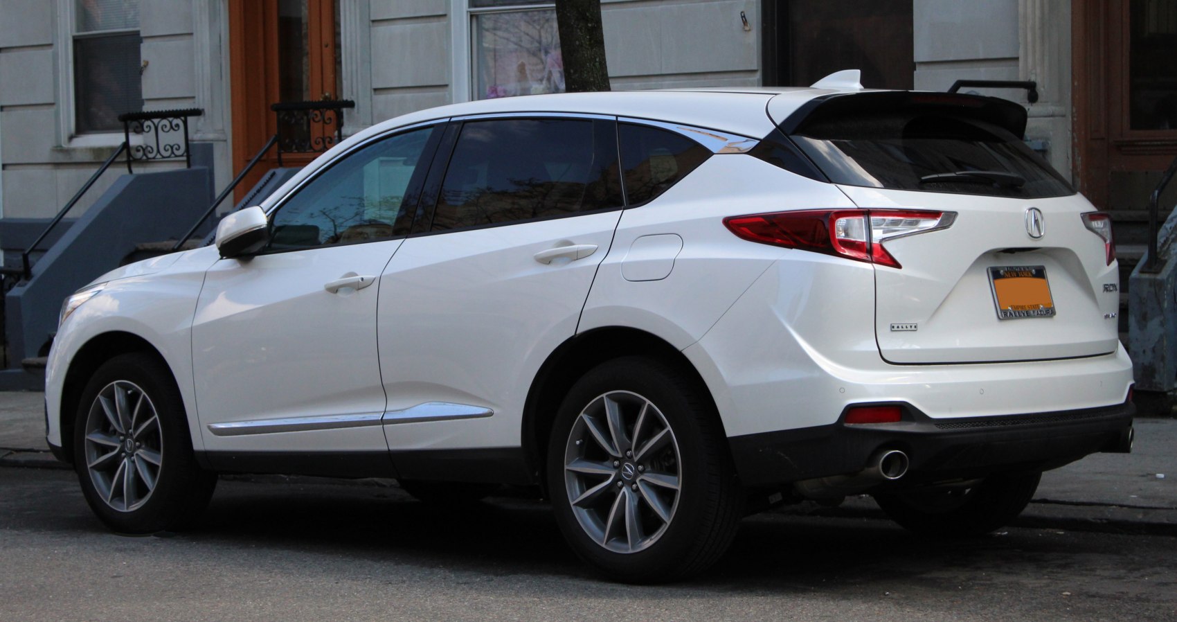 Rear side view of a modern SUV with LED taillights and rear spoiler