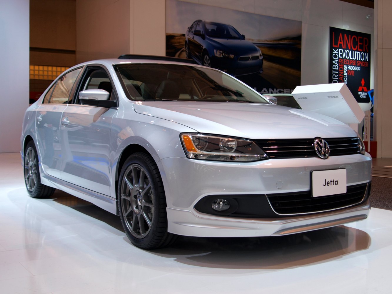 Silver sedan front and side view with alloy wheels
