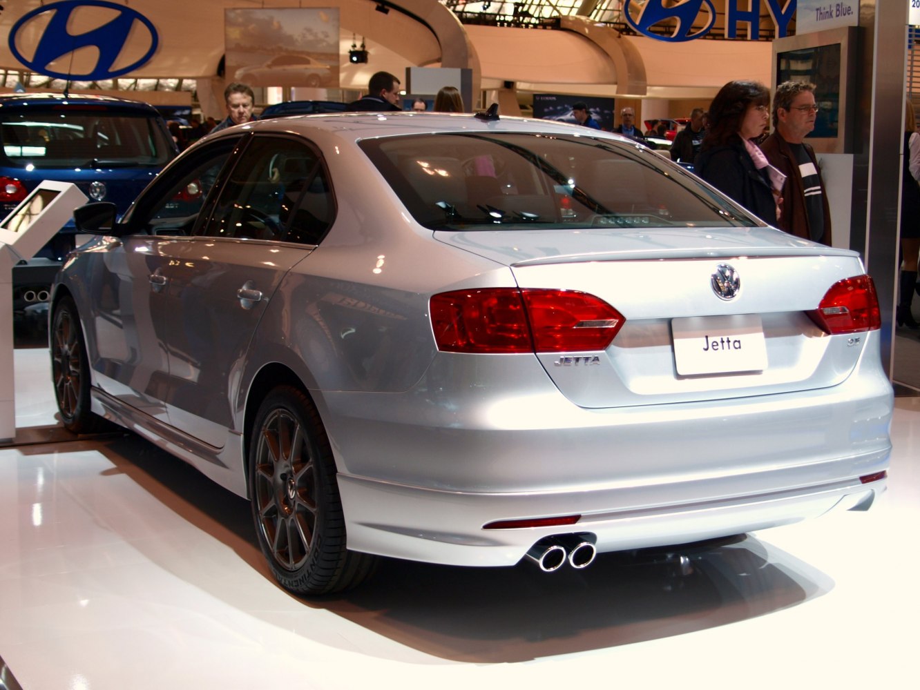 Rear view showing dual exhaust and alloy wheels on a sedan