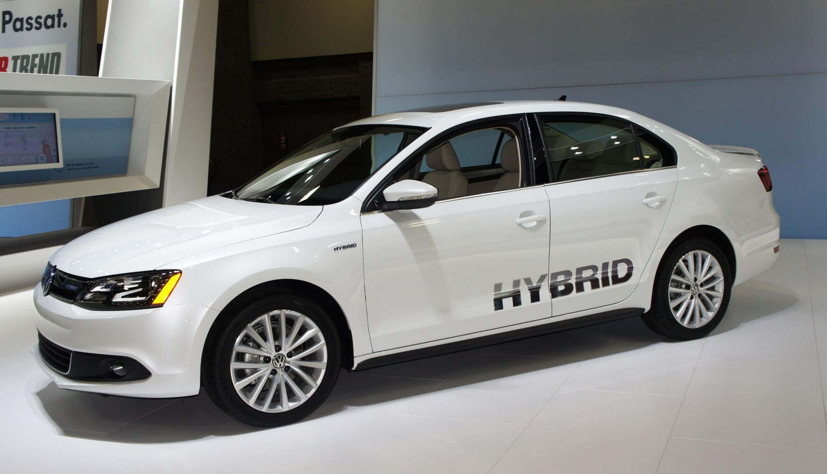 White hybrid sedan with LED headlights and alloy wheels