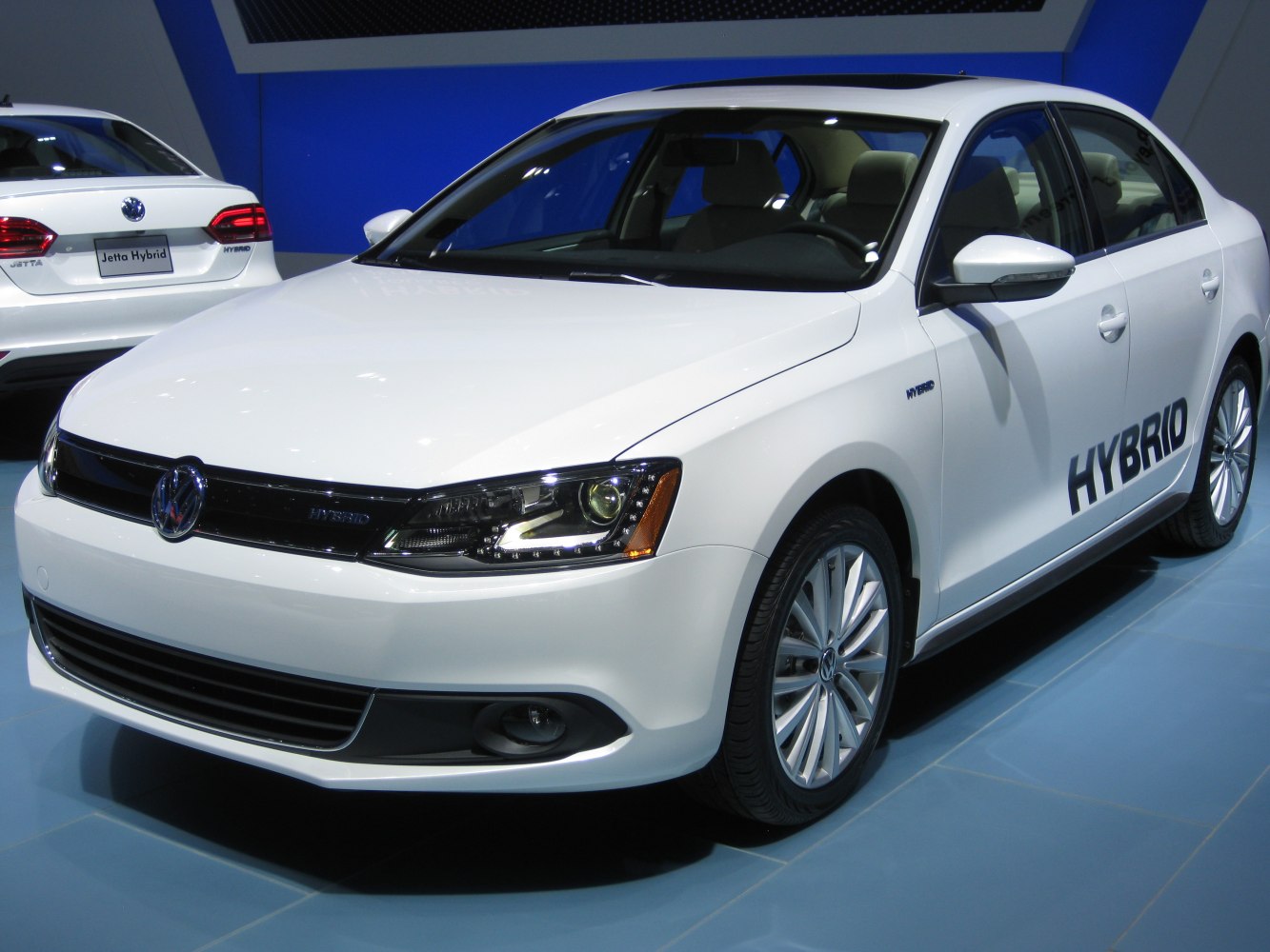 White sedan with hybrid badge and detailed front headlights