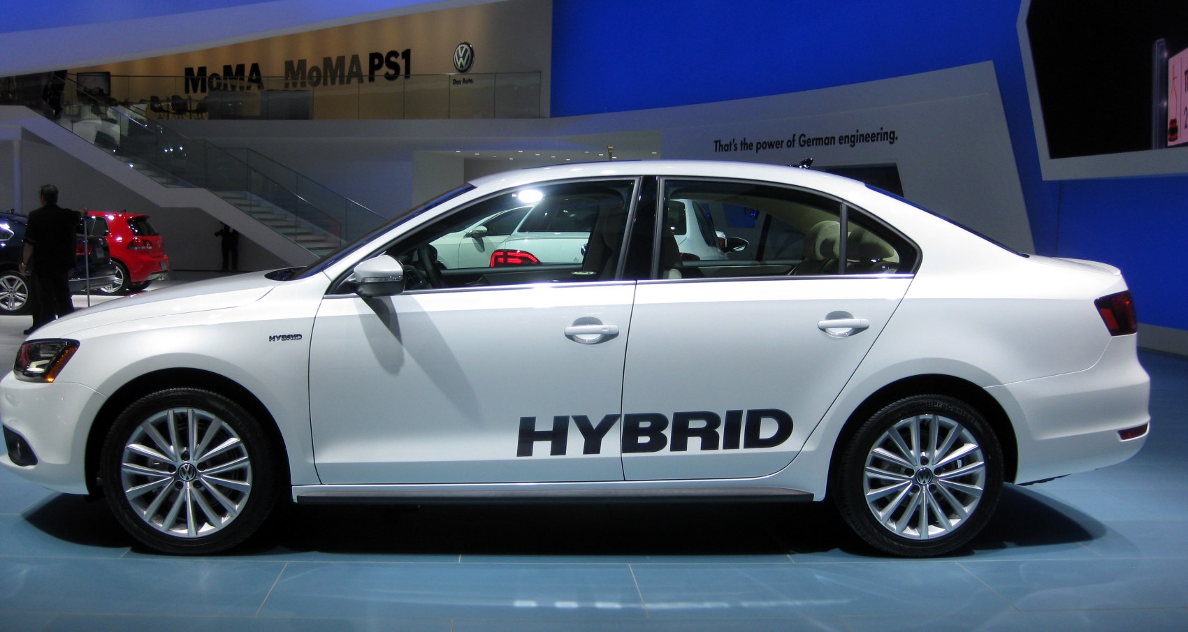 Side profile of hybrid sedan with hybrid badge and alloy wheels