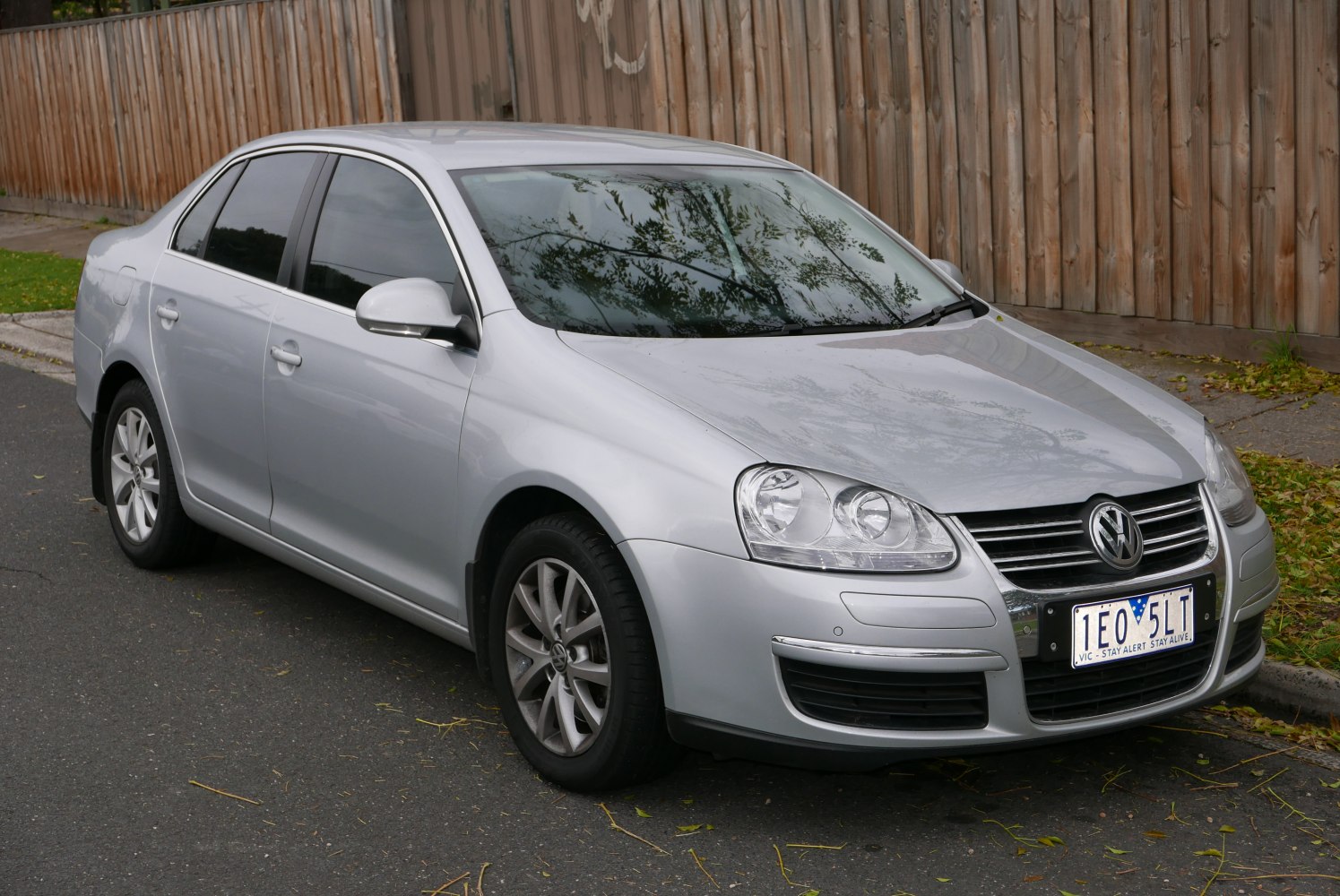 Silver sedan with dual headlights, alloy wheels, and tinted windows