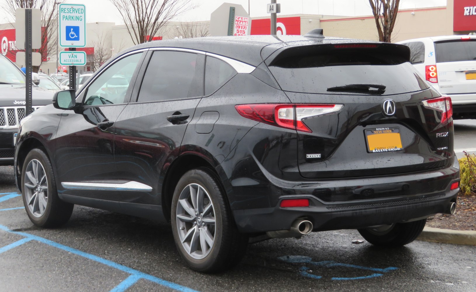 Black SUV rear with distinctive tail lights and chrome trim