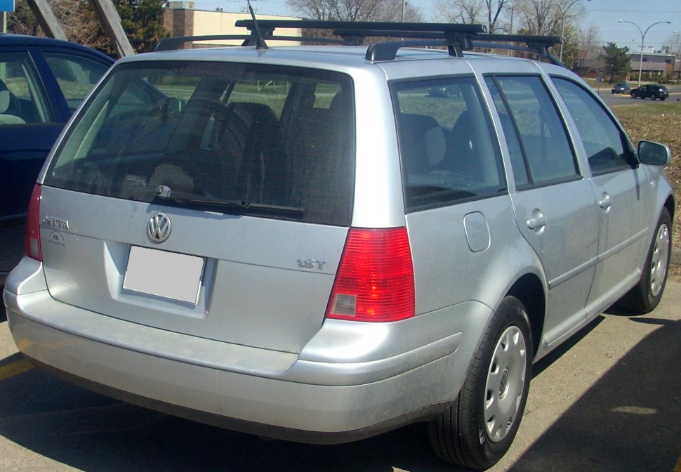 Rear view of silver wagon with roof rack and hatchback design