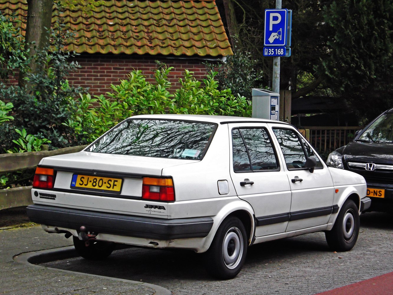 Rear view of a classic 1980s sedan with rectangular tail lights.