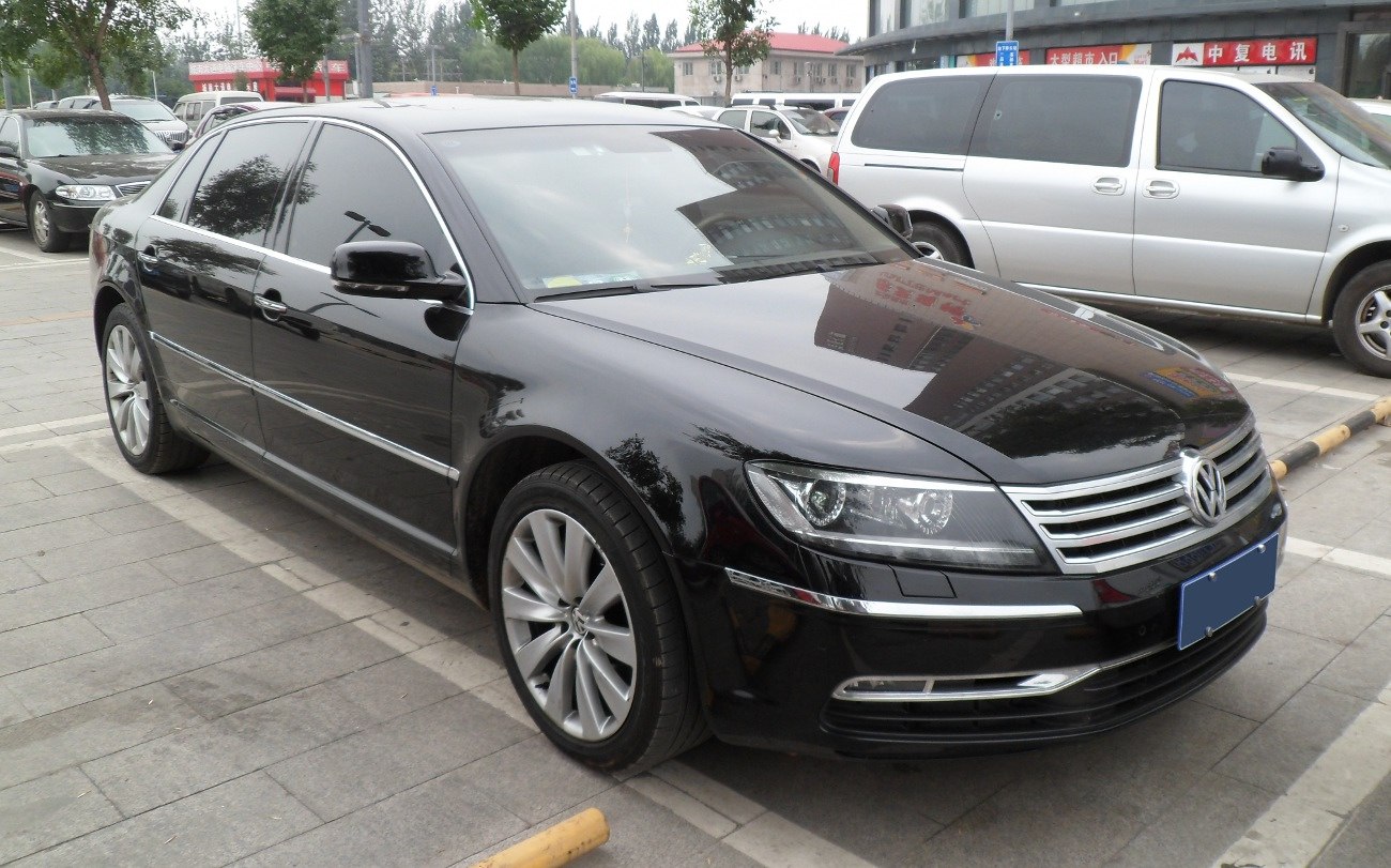 Black luxury sedan with distinctive front grille and LED headlights