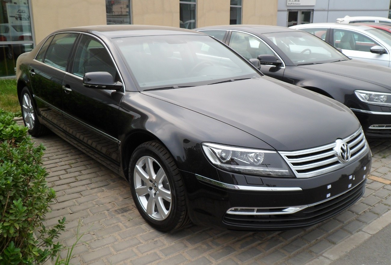 Luxury sedan front view with chrome grille and alloy wheels