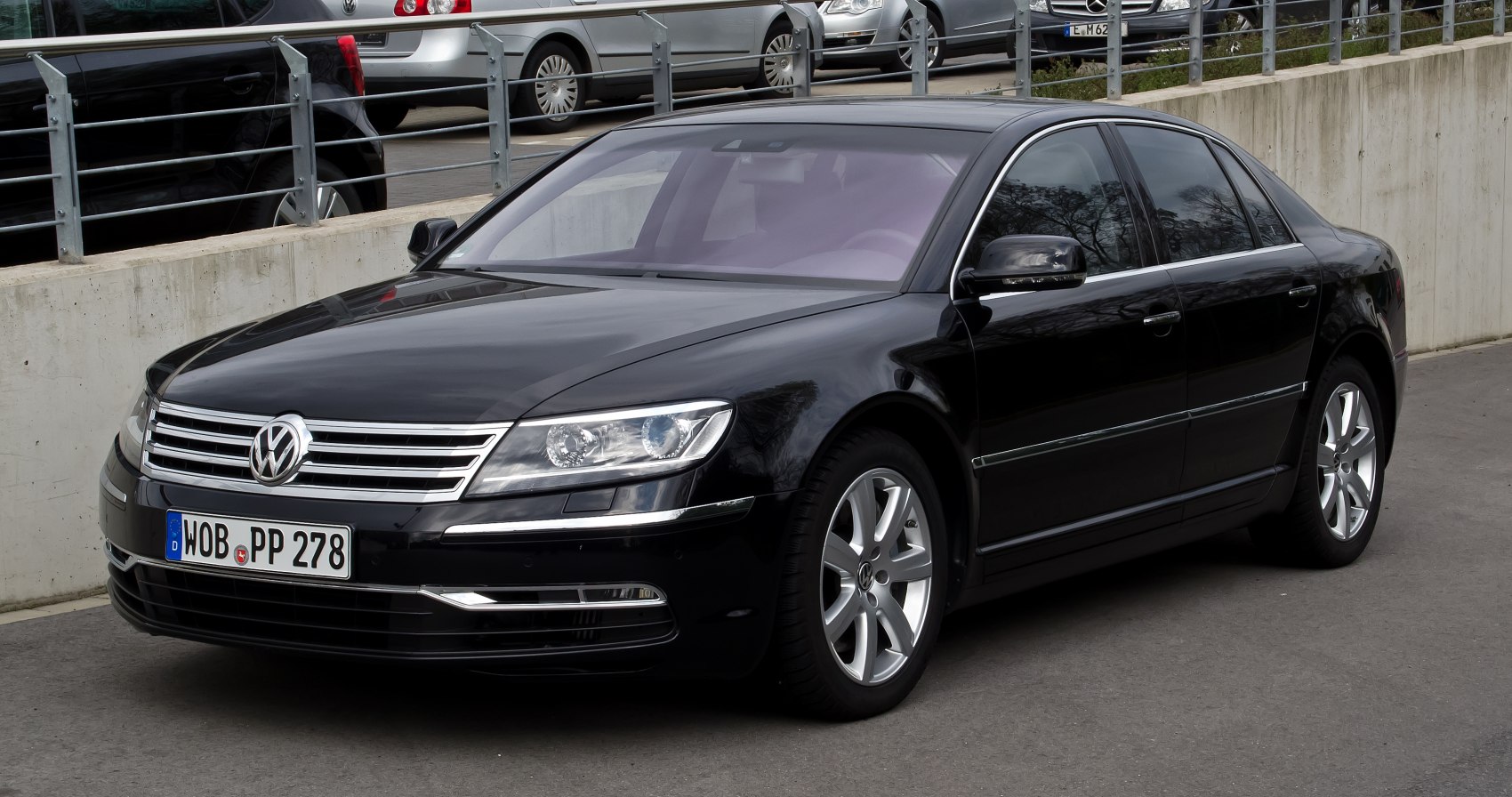 Luxury sedan front side view with chrome grille and alloy wheels
