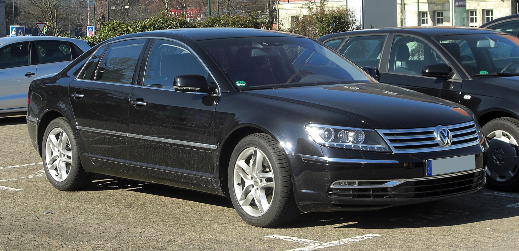 Luxury sedan front and side view with headlights and grille