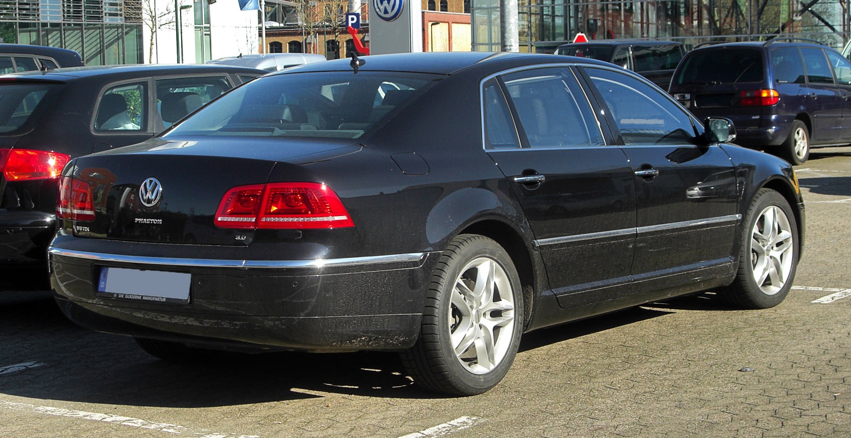 Rear view of sedan with distinctive tail lights and alloy wheels