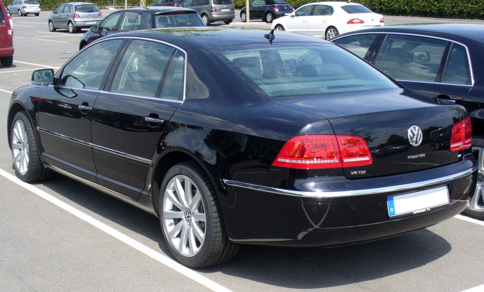 Rear and side view of luxury sedan with alloy wheels and distinctive taillights