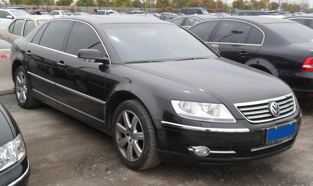 Black luxury sedan with chrome trim and alloy wheels