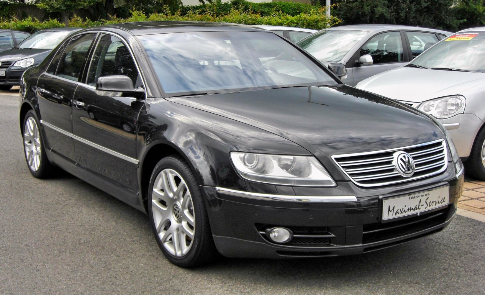 Front side view showing chrome grille and alloy wheels