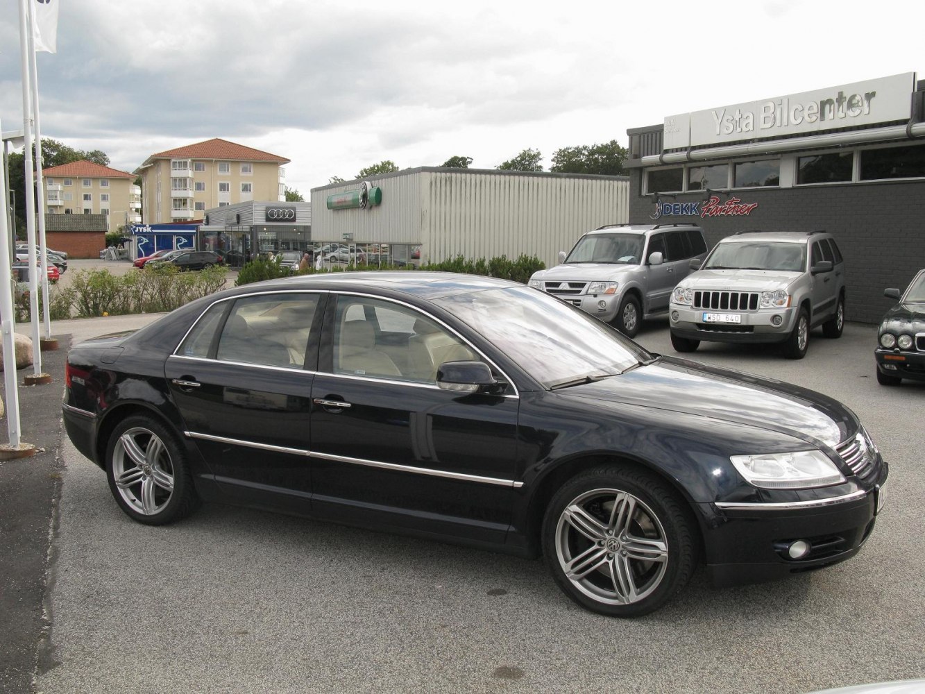 Luxury sedan side profile with alloy wheels