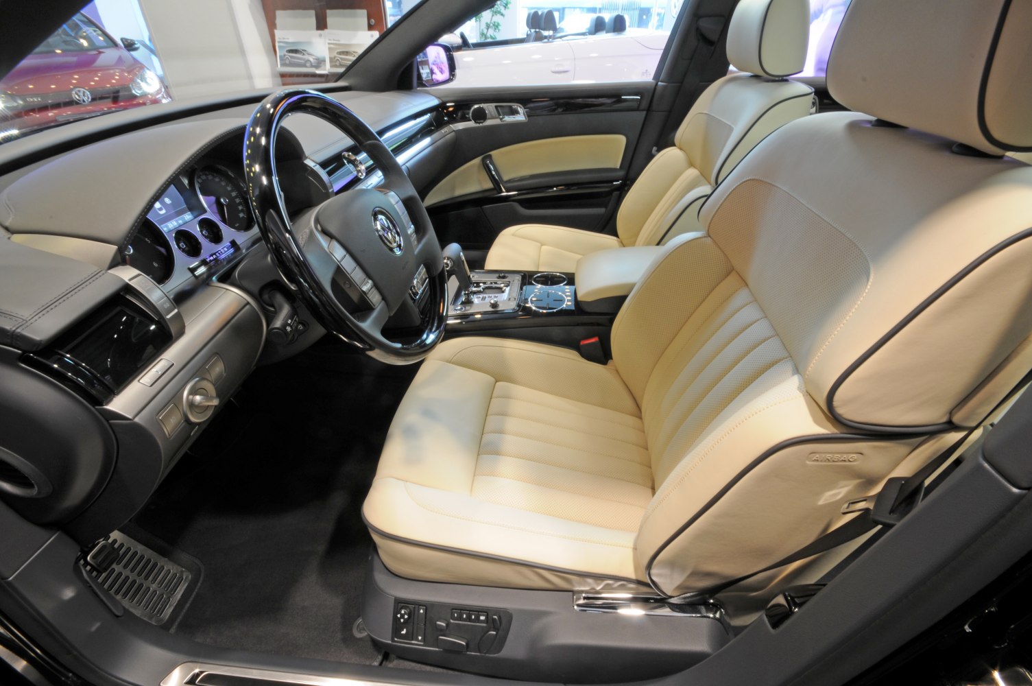 Beige leather seats with advanced dashboard and steering wheel